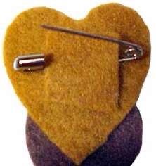 a yellow and purple heart shaped brooch with a metal pin in the shape of a heart