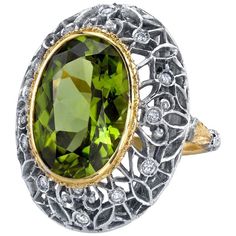 This is a truly beautiful ring, from the size and quality of peridot it features to the exquisite Florentine inspired craftsmanship. The large oval peridot is clear and crystalline, with bright, "Granny Smith" apple green color, set in 18k yellow gold to highlight its beauty. If August is your birth month, peridot is your birthstone. Sparkling round brilliant cut diamonds further adorn the white gold portion of the ring which has been intricately pierced, creating an elegant, regal appearance. Handmade in Italy. Peridot, 16.30 x 11.50 x 7.10mm, 8.85 carats Round brilliant cut diamonds, .24 carat total Ring size 7 Complimentary sizing as needed Peridot Engagement Rings, Granny Smith Apple, Expensive Rings, Peridot Jewelry, Dome Ring, Granny Smith, White Gold Engagement, Domed Ring, Pretty Rings