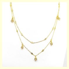 This beautiful necklace has a unique design - a very long chain that can be worn long or doubled, with the help of a toggle closure. It features tulip-shaped crystal drops set along half of the chain. Made of durable and beautiful 14kt gold-plated brass and enhanced with the finest European crystals. The full length is 42" or 20" when doubled. Made in the USA by La Vie Parisienne Elegant Dangle Double Chain Jewelry, Gold Crystal Backdrop Necklace For Formal Occasions, Formal Gold Crystal Backdrop Necklace, Gold Dangle Jewelry With Double Chain, Yellow Gold Crystal Necklace With Adjustable Chain, Gold Crystal Drop Necklace, Elegant Gold Crystal Drop Necklace, Gold Crystal Lariat Necklace, Gold Crystal Pendant Chain Necklace