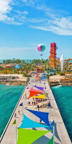 colorful umbrellas line the pier at an amusement park