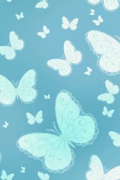 many white butterflies are flying in the sky with blue and white colors on it's wings