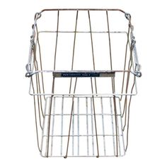 a metal wire basket with a label on the front and back sides, attached to a white background