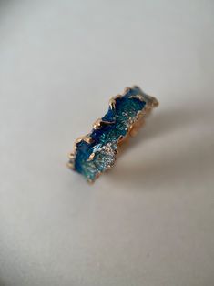 a gold ring with blue crystals on it