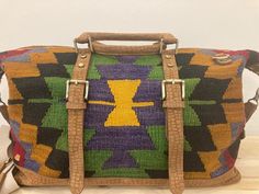 Our Turkish Kilim Leather Duffel Bag is a luxurious and stylish choice for city dwellers and cultural explorers alike. Handmade with top-quality leather and vintage fabrics, this bohemian carry-on is both durable and chic. The spacious interior is perfect for all your travel essentials, while the kilim and leather accents add a touch of unique flair. Whether you're a frequent traveler or a collector seeking a statement piece, this duffel bag is sure to impress. Made from 100% wool, hand-woven vi Boho Style Bag, Leather Duffel Bag, Kilim Bag, Cabin Bag, Leather Duffel, Frequent Traveler, Vintage Turkish Kilim Rug, Handmade Kilim Rugs, Handmade Clothing