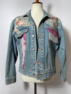 Jordache Vintage Jean Jacket  Take me back to the 80s and 90s! Such a fun statement piece. Floral detailing all over jacket.  --- Condition: Great Vintage Condition. Few normal signs of vintage wear.  --- Size: Fits M best  Shown on size small mannequin  --- All items are uploaded to Instagram first. Follow @bluehoneyshop for first dibs! Retro Spring Outerwear With Patches, 90s Style Spring Denim Jacket, Retro Graphic Print Outerwear For Spring, Retro Spring Outerwear With Graphic Print, Vintage Long Sleeve Denim Jacket For Spring, 90s Spring Outerwear, Vintage Cotton Denim Jacket For Festival, Vintage Embroidered Denim Jacket For Spring, Vintage Denim Jacket With Graphic Print For Spring