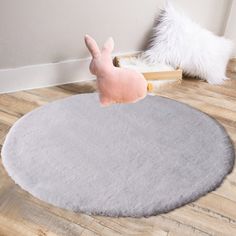 a stuffed animal sitting on top of a rug