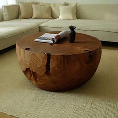 a wooden table sitting on top of a rug next to a couch