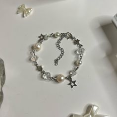 "Pearl Bracelet with Star charms! (adjustable length: with adjuster 5.5\" -> 7.5\") Made with Freshwater pearls, Stainless Steel hardware, and Glass beads Each product is handmade, so slight variations may occur! each is uniquely yours 🤞 🌷͜ (ᵔ ̮ ᵔ)› [ordering 2 or more items from my shop will get you a random freebie]  🍡each order comes with a sticker or candy 🍓CARE INSTRUCTIONS (non ss metals) Keep away from liquids! Creams/Perfumes/Creams, etc. Make sure to remove before showering and slee Bracelet Ideas Metal, Vintage Beaded Bracelets For Gift, Handmade White Beaded Metal Bracelets, Handmade White Beaded Metal Bracelet, Metal Beaded Rosary Bracelet Gift, Metal Beaded Rosary Bracelet For Gift, Vintage Silver Beaded Bracelets As Gift, Bracelet To Make, Small Business Jewelry