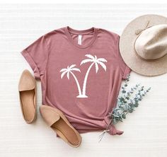 "Palm Tree Shirt, Palms Shirt, Summer Vacation T-Shirt, Palm Beach Shirt, Summer Tee, Botanical Shirt, Hawaii Shirt, Tropical Shirt ☀️☀️☀️☀️☀️ Everything in our shop is hand crafted and made to order. If you want different color or size contact me! If you would like something custom made to fit your personal style please message me and I will do everything to get you that something special. ---How To Order--- ⭐️Please, check and review all photos ⭐️Choose your t-shirt size and color ⭐️Enter your Pink Palm Tree Print Short Sleeve Top, Summer Cotton T-shirt With Palm Tree Print, Spring Crew Neck T-shirt With Palm Tree Print, Pink Cotton Top With Palm Tree Print, Casual Printed Camp Shirt With Crew Neck, Spring Palm Tree Print Short Sleeve T-shirt, Relaxed Fit Palm Tree Print T-shirt, Tropical Cotton T-shirt With Palm Tree Print, Trendy Cotton Tops With Palm Tree Print