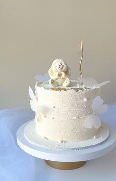 there is a white cake with angel decorations on it