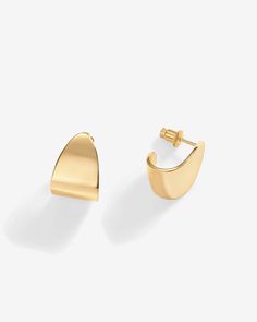 Trendy and chic, these 16mm long and 12mm wide earrings feature an abstract design, making a bold statement. Lightweight and chunky, these hoops offer an elegant blend of sophistication and modern style.Materials 14K yellow gold or white gold plated. s925 Sterling Silver Posts. Measurements: Length: 16mm; Width: 12mm. Hypoallergenic; nickel, lead, and cadmium free. Abstract Design, Modern Style, Gold Plate, Hoop Earrings, Plating, Yellow Gold, White Gold, Sterling Silver, Yellow