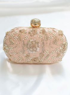 Peach Clutch for Women w/ Zardozi & Pearl embellishment & Gold chain strap Adorned with intricate floral Zardozi embroidery & pearl embellishments. This peach clutch purse with a stone-studded closure at the top is a must-have in your wardrobe - a versatile accessory for any party outfit!  Lining: Fabric Color: Peach Embroidery: Zardozi & Pearl Size & Dimensions:  Height - 5 in Width - 8 in Depth - 1.5 in Fits most of the phones. Strap: Detachable shoulder metal chain strap  Closure: Compartment Hand Embellished Bags For Reception, Feminine Beige Wedding Bags, Handheld Pearl Embroidered Evening Bag For Weddings, Beige Embellished Evening Bag For Party, Pink Embellished Evening Bag, Handheld Evening Bag With Pearl Embroidery For Wedding, Handheld Pearl Embroidery Evening Bag For Wedding, Feminine Beige Party Bag, Festive Luxury Pearl Embroidered Evening Bag