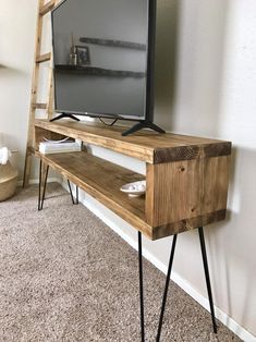 a tv is sitting on top of a wooden shelf