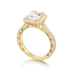 a yellow gold engagement ring with a princess cut center stone and pave set shoulders