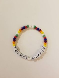 Layer and stack with this super cute rainbow trippy hippie bracelet. Made from high quality durable elastic string and beautiful seed beads that will sit comfortably on your wrist. Secured with a stopper bead and a knot. . CARE: It is best to wear this bracelet by rolling it on and off the wrist to avoid stretching and breakage. These bracelets are not designed to be over stretched and excessive force and pulling can result in breakage. This bracelet is about 6.5 inches. (But made with a little Casual Rainbow Friendship Bracelets With Tiny Beads, Casual White Stretch Bracelet For Festivals, Casual Rainbow Beaded Friendship Bracelets, Bohemian Rainbow Letter Beads Friendship Bracelet, Casual Rainbow Beaded Bracelets For Friendship, Hippie Style Friendship Bracelets With Round Beads, Adjustable Rainbow Friendship Bracelets With Letter Beads, Colorful Adjustable Casual Beads, Colorful Casual Friendship Bracelets With Letter Beads