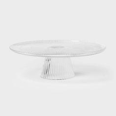 an empty glass cake plate on a white background