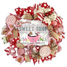 a christmas wreath with candy canes and candies on the front, says santa's sweet shop