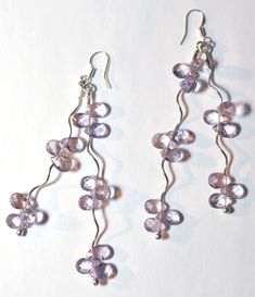 Whether night or day, these delicate Amethyst earrings will be sure to dangle the sorrow away.  The light just dances on these stones and you are sure to turn heads when wearing them.    Stones - Amethyst Finding\/components - Sterling silver  STONE COLOR - Pictures were lighted to show detail. See last picture for actual stone color.  NOTE: Slight variations in the piece you will receive from the one pictured are to be expected due to the hand made nature of the item.   Photos by Evan Spring  A Amethyst Dangle Earrings For Jewelry Making, Handmade Purple Amethyst Chandelier Earrings, Handmade Amethyst Teardrop Crystal Earrings, Lavender Dangle Crystal Earrings, Amethyst Natural Stone Dangle Crystal Earrings, Amethyst Natural Stone Dangle Earrings, Amethyst Dangle Crystal Earrings With Natural Stones, Handmade Amethyst Dangle Crystal Earrings, Handmade Amethyst Crystal Dangle Earrings