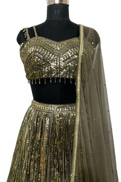 Description: - Blouse is based on net fabric and is designed in a sweetheart neckline with sleeveless with sequins and cut dana all over. Back is sheer net.The Shimmery lehenga skirt on Georgette has vertical shimmer lines and is completed with soft net attached dupatta in complementing color. Garment is chic and sophisticated. Color Golden & Mehandi Green Fabric Georgette, Net Occasion Party Wear Wedding Wear Style Lehenga Choli Work Embroidery Chest Size 38 Lehenga Length 45 Please note: Origi Shimmery Lehenga, Kurta Pajama Men, Sequence Blouse, Indo Western Gown, Saree Petticoat, Full Sleeve Blouse, Saree Jewellery, Green Lehenga, Lehenga Skirt