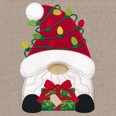 a santa hat with lights on it is hanging from the side of a piece of fabric