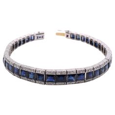 Fine Art Deco bracelet from ca 1925 made in France. Set in platinum with a center channel of 41 dark blue well saturated step cut sapphires and embellished with small bright white old cut round diamonds on either side. The sides of this gorgeous bracelet have fine hand engravings. Signed Laillet Paris with French assay marks accompanied by the original leather bracelet case form the maker. Bracelet Art, Art Deco Bracelet, Step Cut, Gorgeous Bracelet, Sapphire Diamond, Hand Engraving, Link Bracelets, Made In France, Round Diamonds