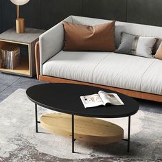 a living room with a couch, coffee table and bookshelf on the floor