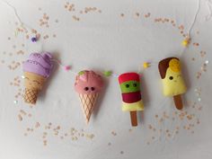 three ice cream cones are hanging on a string