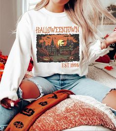 Halloweentown Est 1998 Tee/Sweatshirt Comes in 4 colors - White, Ash Grey, Tan and Black Tee: $32Sweatshirt: $48Unisex sizing Sizes: S-4XLTAT: 7-10 business days 90s Long Sleeve Sweatshirt For Fall, 90s Letter Print Sweatshirt For Fall, 90s Style Letter Print T-shirt For Fall, 90s Letter Print Sweater For Fall, White 90s Sweatshirt For Fall, 90s Style Long Sleeve T-shirt For Fall, 90s Style Long Sleeve Fall Sweatshirt, 90s Long Sleeve T-shirt For Fall, 90s Letter Print Fall Sweater