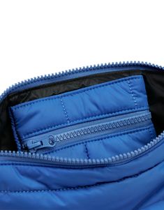 the inside of a blue jacket with zippers