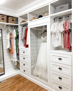 a white closet filled with lots of clothes