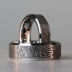 two wedding rings with fingerprints on them