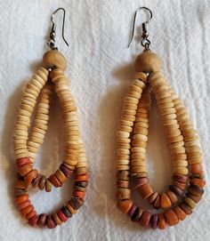 Dangle earrings 3.5 inches long. Faux wood beads. Colors ranging from tan to sienna, with a bit of brown. Excellent condition. For pierced ears. Beads Colors, How To Make Earrings, Faux Wood, Pierced Ears, Wood Beads, Ear Piercings, Bead Work, Favorite Jewelry, Jewelry Earrings Dangle