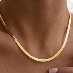 Gold Snake Chain Necklace – Sleek and Timeless Elegance Embrace the allure of understated luxury with our Gold Snake Chain Necklace. This sleek, polished chain drapes effortlessly around your neck, offering a refined touch to any ensemble. Its versatile design makes it perfect for layering or wearing solo, adding a sophisticated finish to both casual and formal looks. 18k Gold Plated Brass Gold Snake Link Chain Measures 14 Inches with an additional 3 Inch Extention Thickness 3.1 mm Lobster Clasp Minimalist Snake Chain Necklace For Formal Occasions, Modern Herringbone Necklace For Formal Occasions, Tarnish Resistant Herringbone Necklace For Formal Occasions, Classic Clavicle Chain Necklace For Everyday Luxury, Timeless Tarnish Resistant Chain Necklace, Elegant Snake Chain Necklace, Formal Classic Snake Chain Necklace, Elegant Delicate Snake Chain Necklace For Formal Occasions, Elegant Chain Necklace For Everyday Luxury