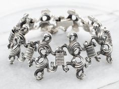 This ornate vintage bracelet is a timeless piece of jewelry crafted from sterling silver, featuring an ornate link design for an elegant finish. Perfect for any occasion, this exquisite bracelet is sure to make a statement.Metal: Sterling SilverWidth: 35.3 mmInside Circumference: 8 InchesMarks: ".925 BAS" Stamped on the clasp Link Design, Pocket Watch Chain, Vintage Bracelet, Watch Chain, Vintage Bracelets, Pearl Pendant, Charm Earrings, Beaded Chain, Link Bracelets