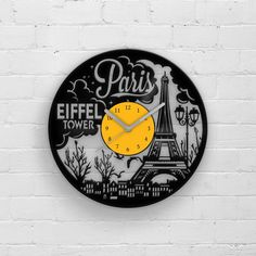 a clock with the words paris and eiffel tower on it