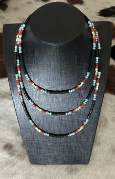 This set consists of items 169B, 170B and 171B These necklaces are made with genuine black onyx, turquoise, red coral and mother of pearl heishi beads. They are beautifully accented with 925 sterling silver pearl beads. $115 Black Heishi Beads Jewelry, Handmade Southwestern Black Beaded Necklace, Handmade Black Heishi Beads, Black Single Strand Bohemian Jewelry, Bohemian Black Single Strand Jewelry, Black Multi-strand Hand-strung Jewelry, Black Heishi Beads Necklace For Gift, Handmade Southwestern Black Beads, Southwestern Black Beaded Necklaces For Gifts