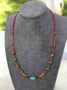 "Authentic Native American, handmade, Cedar Juniper Berry seed necklace with turquoise gemstone. Cedar beads, colorful glass seed beads (size 11/0), round silver beads (6mm) and a gemstone bead are strung with jewelry wire and closed with lobster claw clasp. Navajo legend says Cedar beads, also known as \"Ghost Beads,\" will keep evil spirits and bad dreams away. For example, it is customary for Navajo mothers to place strung cedar beads on/near their traditional cradle boards used by their infa Handmade Southwestern Necklace For Beach, Handmade Bohemian Turquoise Necklace With Oval Beads, Handmade Turquoise Necklace With Oval Beads Gift, Artisan Tiny Turquoise Beads, Unique Turquoise Jewelry With Tiny Beads, Adjustable Artisan Turquoise Necklace With Heishi Beads, Adjustable Artisan Turquoise Heishi Beads Necklace, Southwestern Colorful Beaded Necklaces For Crafting, Adjustable Bohemian Turquoise Necklace With Heishi Beads