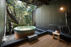 a large bath tub sitting on top of a wooden floor