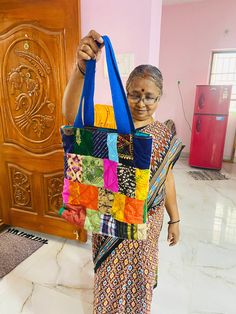 Ever wanted a bag that can carry almost everything that you can carry- this is one such bag. Made completely from tiny pieces of fabric thrown away by tailors, this patchwork tote bag is a perfect mix of style and utility.  It is a 13" x 14" with a 3" base as well. Has a pocket on the inside for you to quickly take out something you might need. The handle is made out of woven cotton. The inside lining is pure cotton. Completely washable, can handle weight upto 4 kgs. Please wash in cold water as it is good for the environment too.  Please note: The images are just a representation of the bag- every bag you see is unique. You can choose the colour of the handle. Rest is a mix of different colours and material. The colours of the patches you receive might not match the patchwork shown in the Colorful Patchwork Shoulder Bag For Daily Use, Colorful Patchwork Shoulder Bag For Everyday Use, Colorful Patchwork Bags For Daily Use, Colorful Patchwork Bags For Everyday Use, Green Patchwork Tote Shoulder Bag, Green Patchwork Shoulder Bag For Daily Use, Green Patchwork Shoulder Bag For Everyday, Multicolor Patchwork Tote Bag, Everyday Green Patchwork Bags