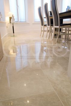 a dining room table and chairs with white marble flooring