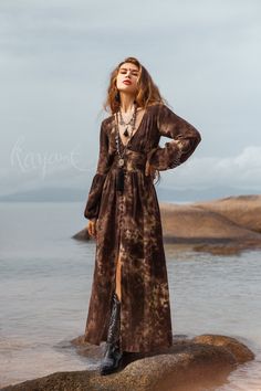 Introducing our gorgeous Brown Tie Dye Maxi Dress, a stunning combination of boho-chic and comfort. Crafted from ultra-soft organic cotton gauze, this dress offers a luxurious and gentle feel against your skin. The mesmerizing tie-dye pattern in rich brown adds a touch of uniqueness and artistry to your wardrobe. Each piece is carefully hand-dyed, creating a one-of-a-kind masterpiece that reflects the beauty of organic dyeing techniques. The long puffy sleeves evoke a sense of effortless elegance.  The elastic on the back waist ensures a super easy and comfortable fit, while enhancing your natural curves. The front of the dress is adorned with fabric-covered buttons, carefully crafted by hand for a truly distinctive touch. All of our colors are achieved through our botanical eco dye proces Ankle Boots With Dress Maxi, Ankle Boots Dress Maxi, Country Hippie Dress, Turtleneck Boho Dress, Luxury Cotton Long Sleeve Maxi Dress, Luxury Bohemian Festival Maxi Dress, Youre A Jewel Maxi Dress, Luxury Bohemian Fitted Maxi Dress, Luxury Bohemian Day Dress