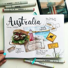 an open book with drawings and markers on the cover that says australia in front of it