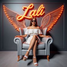 a woman sitting on a chair in front of a neon sign that says lati