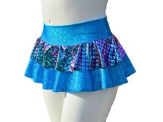 "Stand out in the music festival crowd in this Made-To-Order Holographic Mermaid Rave Skirt! Not only is it beautiful, but the skirt is made from quality performance spandex that is comfortable and will last. The waistband is a double layer of spandex and the skirt is a full circle. The base skirt is hemmed. Feel free to twirl, dance, and sit comfortably in this skirt.  Size Chart (by waist measurement) **Please measure where you will wear the waistband to insure the proper fit** XS 24-26\" S 27-29\" M 30-33\" L 34-36\" XL 37-39\" 2X 40-42\" Lengths are measured from the top of the waistband to the bottom of the base skirt. The waistband is approximately 3\" tall. Micro 10\" Mini 12\"  Sport 15\"  Optional attached shorts will be made out of the same fabric as the main base skirt and will Mermaid Short Skirt, Rave Style Festival Bottoms, Short Cut, Rave Style Short Festival Bottoms, Cheerleading Mini Skirt Bottoms With Built-in Shorts, Cheerleading Mini Skirt With Built-in Shorts, Fitted Mini Skirt With Built-in Shorts For Cheerleading, Stretch Rave Shorts, Disco Style Stretchy Shorts, Disco Stretch Shorts