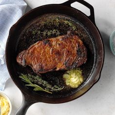 a steak is cooking in a cast iron skillet