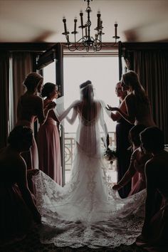 the bride is getting ready to walk down the aisle with her bridal party in tow