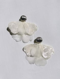 Alina Flower Petal earrings is another signature piece in the Jänkälä collection. 100-year-old Japanese satin flower petals are paired with vintage metal clip-ons. The union of the delicate and the hardy creates a boldly elegant statement piece that will garner attention wherever you go. The earring length is 4.5 inches and clip-ons are 28mm wide. Lovingly handmade by Karo at her home studio in Los Angeles. Handle with care and be kind to yourself. Flower Petal Earrings, Petal Earrings, Aesthetic Jewelry, Satin Flowers, Flower Petal, The Union, Anklet Jewelry, Jewelry Holder, Be Kind To Yourself