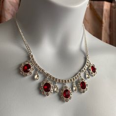 Royal Red Necklace And Pierced Earrings Set Beautiful For The Holidays Or That Special Occasion! Rhinestones Set In Silver-Tone With Red Rhinestones. Classy Elegance! Pe Are 1/2” Oval Shaped Necklace Total 20” Long And Has 3” Adjustable Chain. New In Box Red Crystal Dangle Jewelry, Red Rhinestone Necklace For Party, Red Dangle Necklaces For Party, Red Rhinestone Party Necklaces, Red Rhinestone Party Jewelry, Red Sparkly Jewelry For Formal Occasions, Red Metal Jewelry With Rhinestones, Elegant Red Rhinestone Necklace, Red Sterling Silver Jewelry With Sparkling Stones