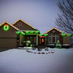 a house is decorated with christmas lights and wreaths