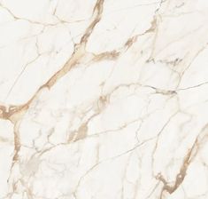 a white marble textured surface with gold veining